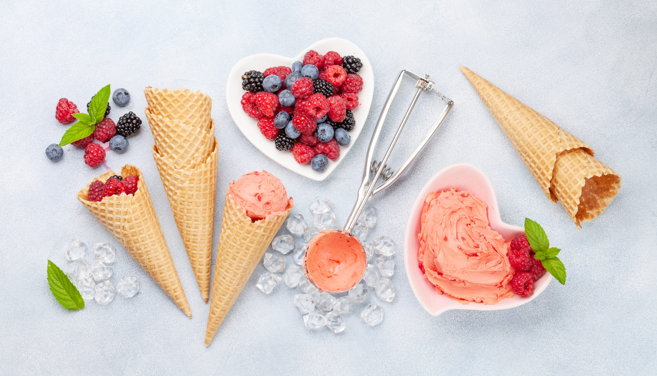 Berry ice cream, waffle cones and berries